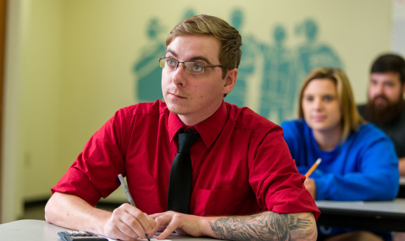 Student at a desk taking notes