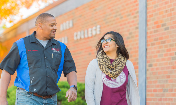 Two Manhattan Tech students walking in front of the main building